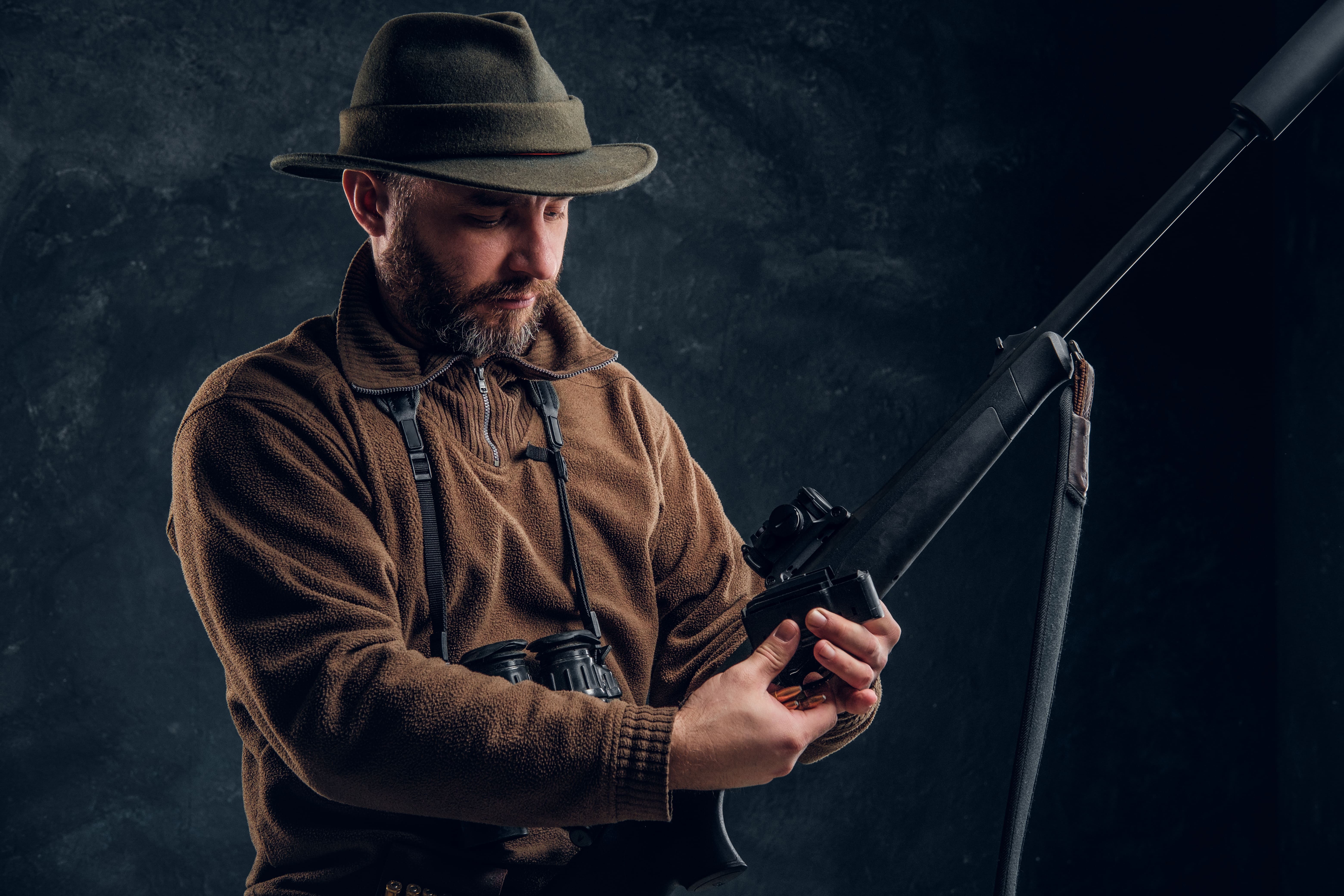 opening-spring-hunting-season-hunter-ready-hunt-charging-hunting-rifle-studio-photo-against-dark-wall-background (1).jpg